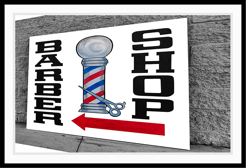 A large barber shop sign on the street.